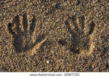 hand print on the rocky beach