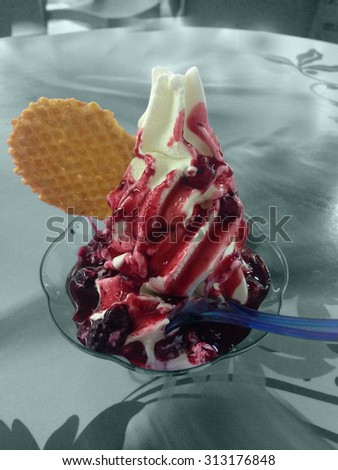 Ice cream black cherry, garnished with cherry syrup in the glass cup