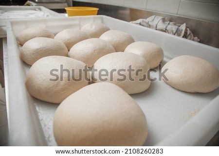 Similar – Image, Stock Photo Kneading pizza dough on green table. Making dough at home