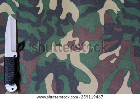 camouflage texture of the material with a knife