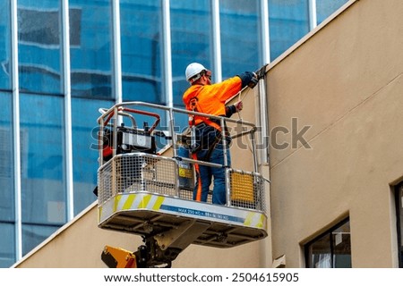 Similar – Image, Stock Photo Electrician working on the distribution panel of a house