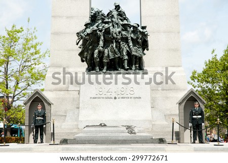 OTTAWA, CANADA - May 26, 2015: Ceremonial guards stand ground at the base of the War Memorial & tomb of the unknown soldier