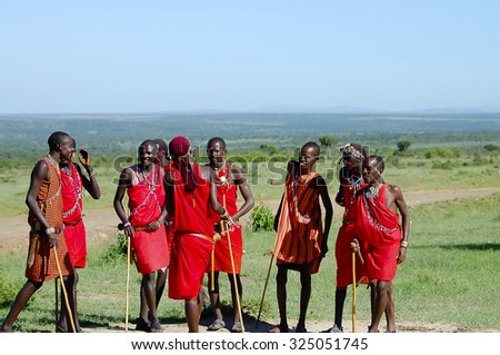 MASAI MARA RESERVE, KENYA - NOVEMBER 25, 2008: Masai people having a chat in the natural reserve of the Masai Mara
