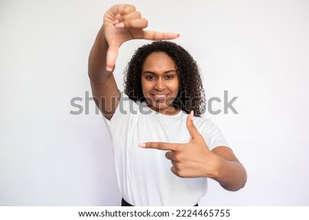 Similar – Image, Stock Photo Cheerful black showing frame gesture on city street