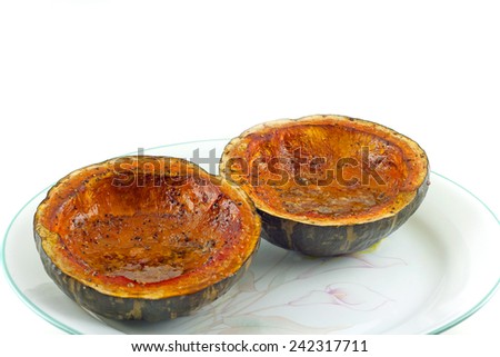 Fresh baked squash plated on a white background.