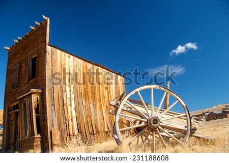 Old wagon in front of delapitated old wooden building, Bodie State Historic Park, California