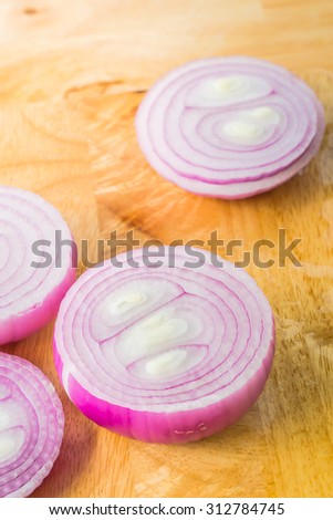Pattern and texture from fresh organic onion on wooden background