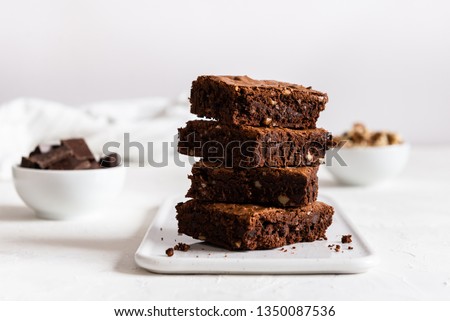 A stack of chocolate brownies on white background, homemade bakery and dessert. Bakery, confectionery concept