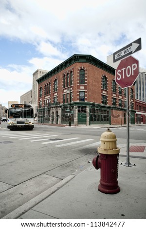 Street corner in Detroit Michigan USA. A city bus in rounding the corner.