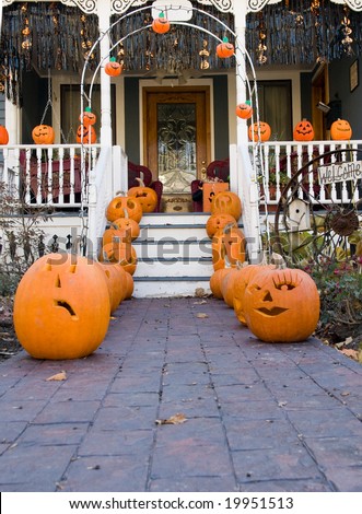 Front porch and walkway decorated with pumpkins for Halloween