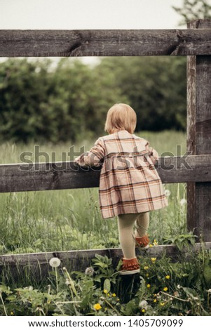 Similar – Image, Stock Photo Girls climb a fence in the spring in the garden.The concept of childhood, cheerfulness, carefree.