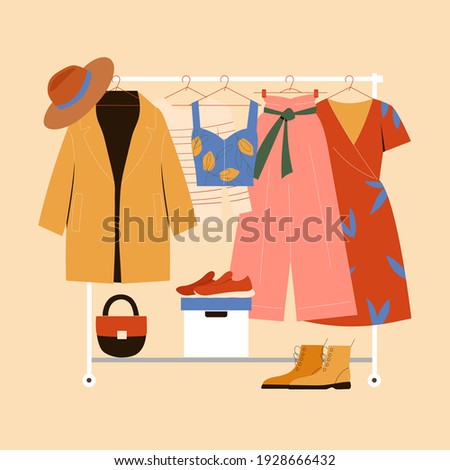 Clothes hanger, garment rack, showroom and clothing organization concept. Clothes, hangers, shoes, bags.
