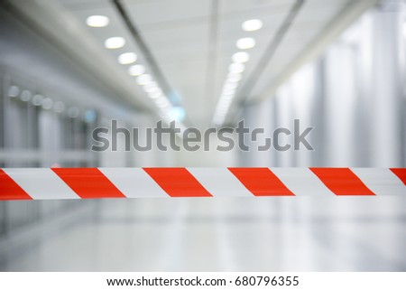 Red and White Lines of barrier tape. At subway station of airport background.Red White warning tape pole fencing is protects for No entry Stock foto © 