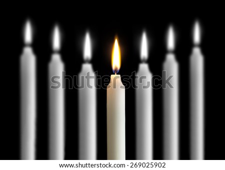 burning candle flame color, black and white in the background blurred burning candles