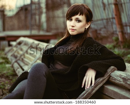 beautiful mysterious girl in dark clothes outdoors