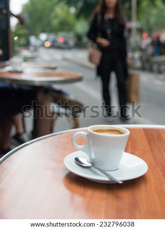 Coffee cup on the table at a cafe in Paris, France