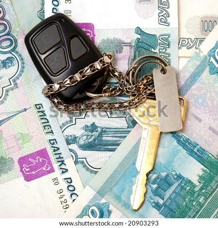 Key from machine and board to safe signalizing on background of the money.