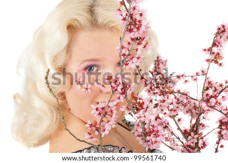 Sensual portrait of a spring woman with flowers on the face and  fancy makeup  cherry blossom portrait studio shoot isolated  on the white.