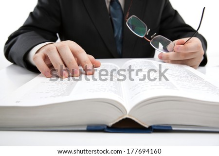 man is looking for information in the dictionary close-up