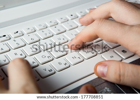 human fingers on the notebook keyboard close-up