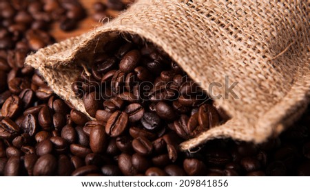 roasted coffee beans and coffee bag closeup