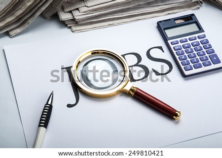 title jobs with loupe, pen, newspapers  and calculator