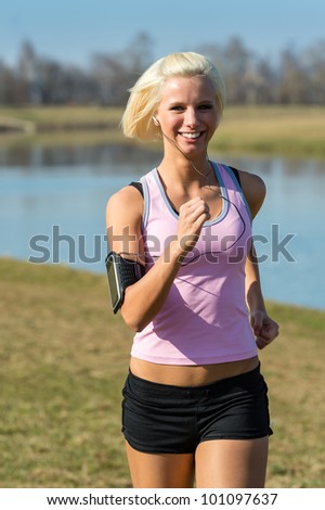 Young woman jogging recreational running by river sunny day