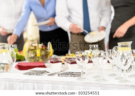 Business catering people serving themselves buffet at company meeting