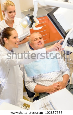 Portrait of mature man consultation with dentist surgeon stomatology clinic