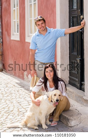 Young couple resting with dog on street stairs happy pet