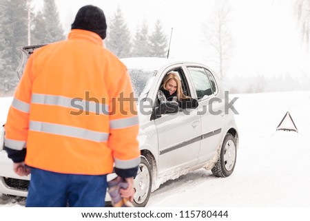 Man helping woman car breakdown assistance snow happy broken winter