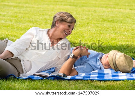 Elderly couple enjoying relax time in sunny park