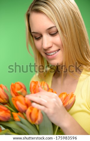 Woman looking down spring flowers orange tulips looking down