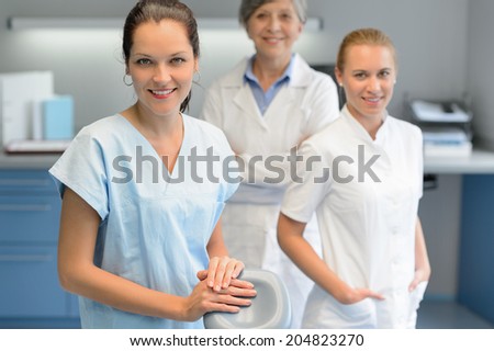 Three dentist woman team at dental surgery looking camera portrait