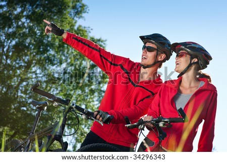 Young sportive couple with mountain bikes having fun