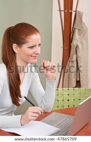 Young  long red hair attractive business woman working at office with laptop
