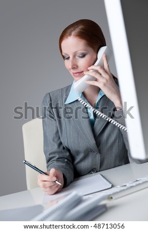Successful business woman on the phone calling at office