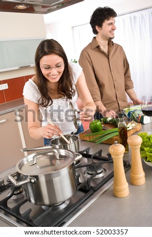 Young couple cooking together in modern kitchen together