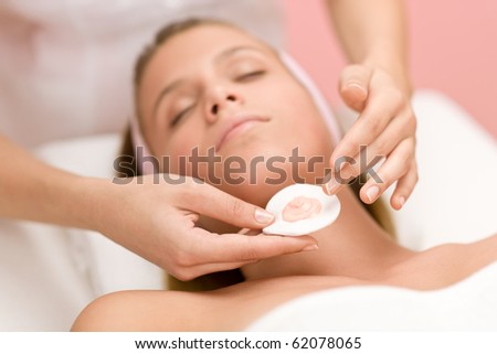 Luxury facial care - woman in spa salon receiving beauty treatment