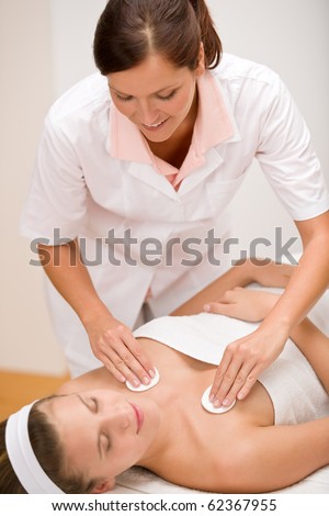 Luxury care - woman at cleavage cleaning in day spa center