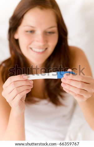 Pregnancy test - happy surprised woman, positive result