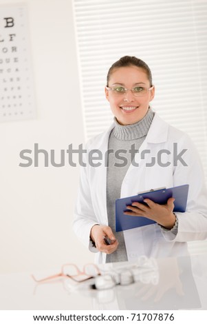 Optician doctor woman with prescription glasses and eye chart