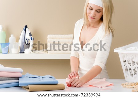 Laundry ironing - woman folding clothes, housework