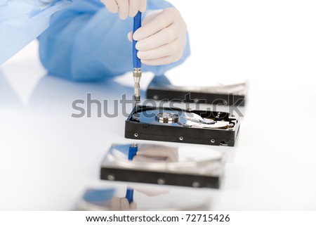 Computer engineer repair hard disc defect, experiment in sterile laboratory