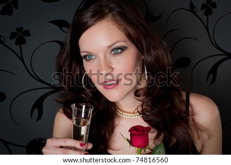 Cocktail party - woman drink champagne hold red rose