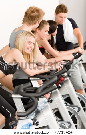 Fitness group of people on bicycle at gym
