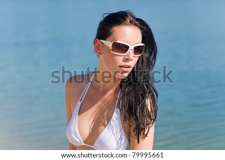 Close-up of young sexy bikini model with white sunglasses