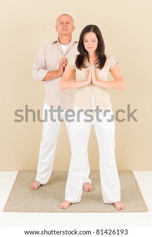 Casual businessman and businesspeople doing yoga standing meditation closed eyes