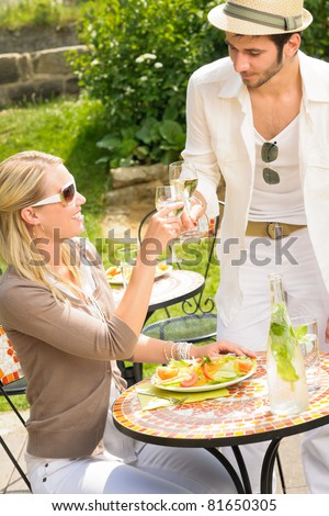 Italian elegant young people dining at outdoor restaurant terrace