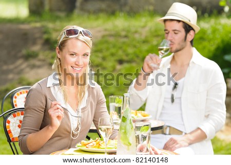 Italian elegant young couple dining at outdoor restaurant terrace